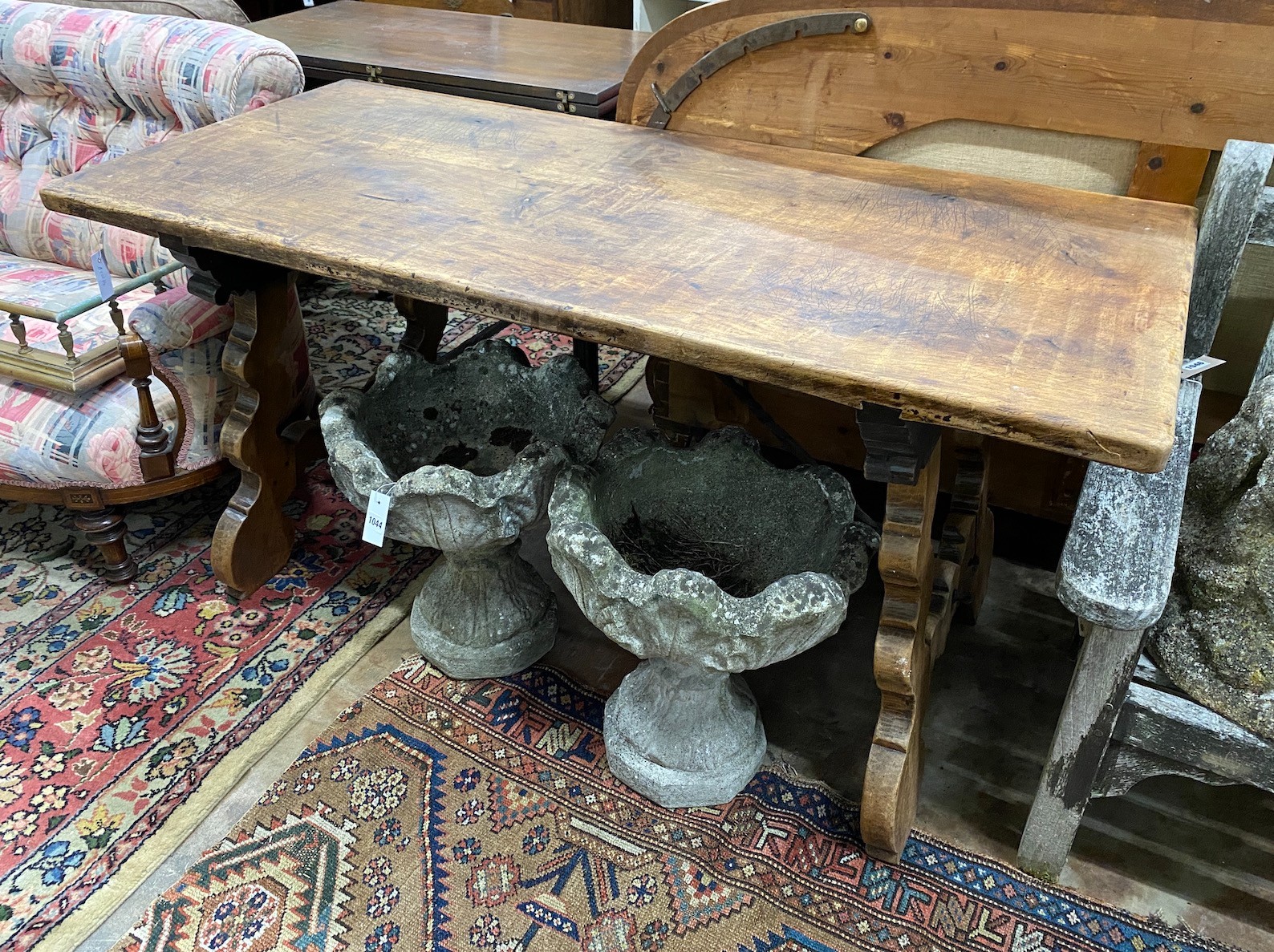 A Spanish walnut centre table, with wrought iron stretcher, width 151cm depth 69cm height 75cm
